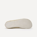 The grey suede outsole of a barefoot dance sneaker shoe shown from a side profile view against a clean white background.