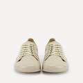 A pair of cream-colored leather lace-up barefoot dance sneakers with beige laces and silver eyelets, displayed on a clean off-white background.